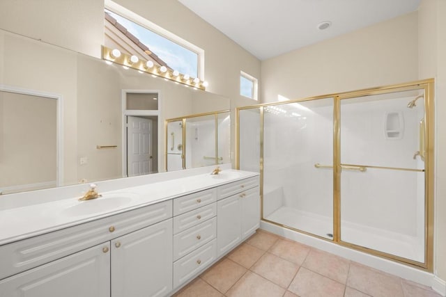 bathroom featuring vanity, a shower with shower door, and tile patterned flooring