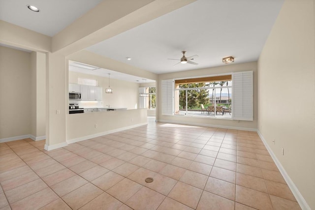 unfurnished living room with ceiling fan and light tile patterned flooring