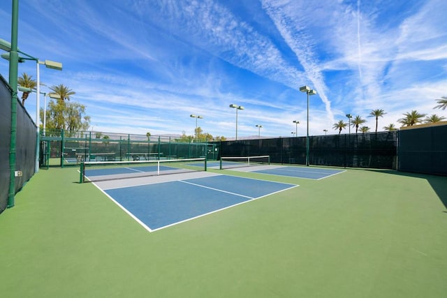 view of tennis court featuring basketball hoop