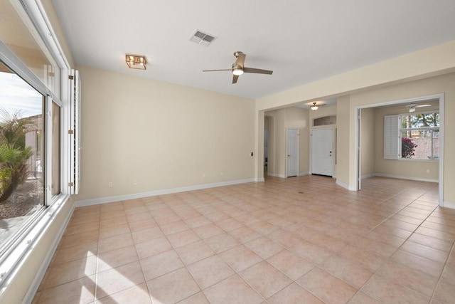 tiled empty room with ceiling fan