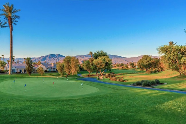 view of home's community with a mountain view and a lawn