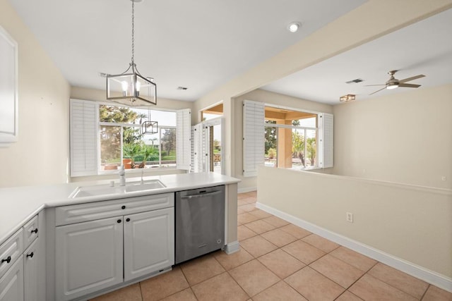 kitchen featuring a wealth of natural light, dishwasher, decorative light fixtures, white cabinetry, and sink