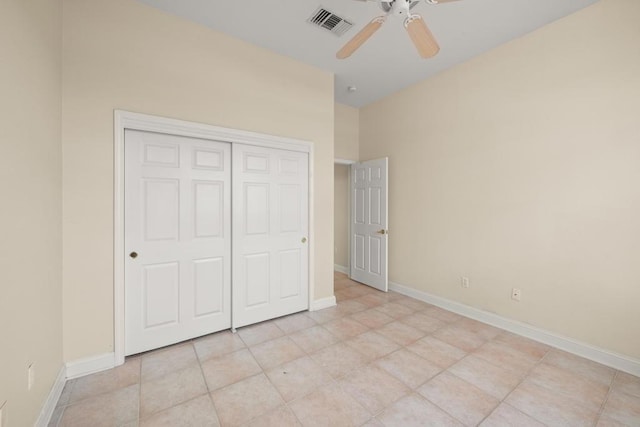 unfurnished bedroom with a closet, ceiling fan, and light tile patterned flooring