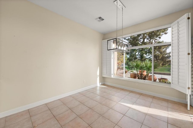 unfurnished dining area featuring light tile patterned flooring and a notable chandelier