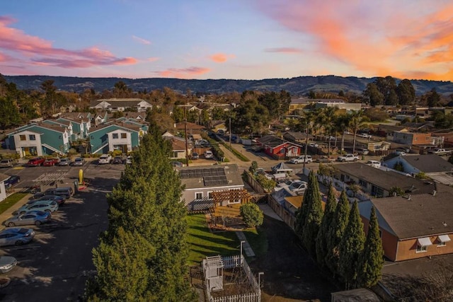 aerial view at dusk featuring a mountain view