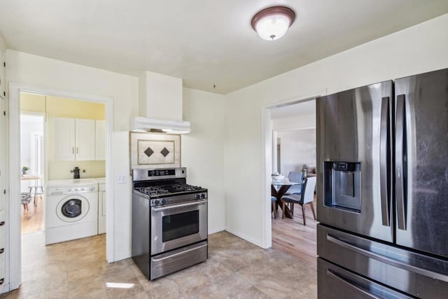 kitchen with premium range hood, white cabinetry, stainless steel appliances, washer / clothes dryer, and decorative backsplash