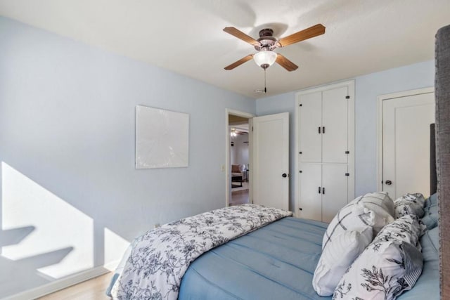 bedroom featuring ceiling fan and light hardwood / wood-style flooring