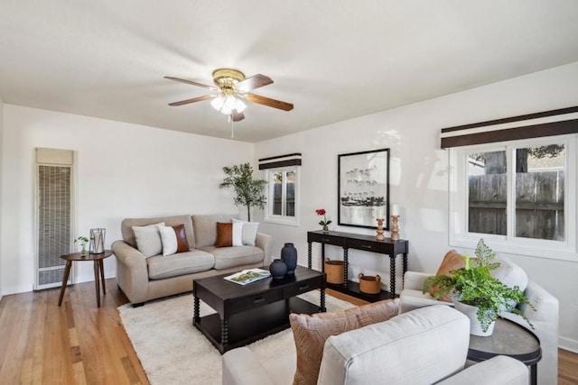 living room with ceiling fan and light wood-type flooring