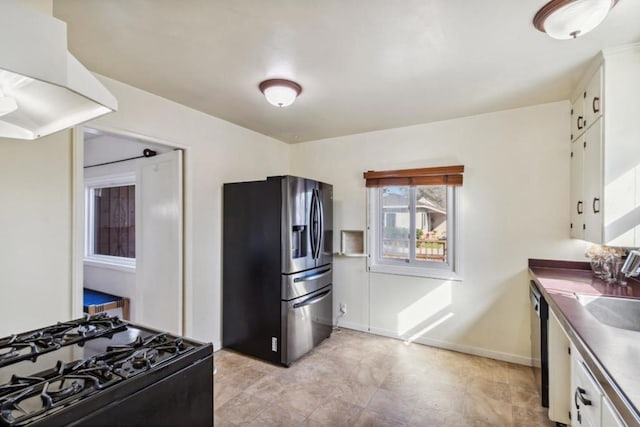 kitchen featuring white cabinets, black gas range, and stainless steel fridge with ice dispenser