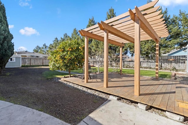 view of yard featuring a wooden deck, a storage unit, and a pergola