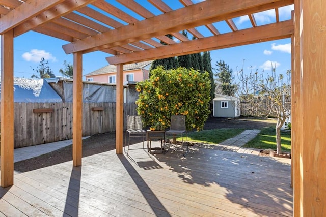 wooden deck featuring a storage shed and a pergola