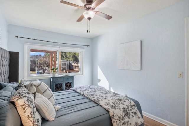 bedroom featuring hardwood / wood-style flooring and ceiling fan