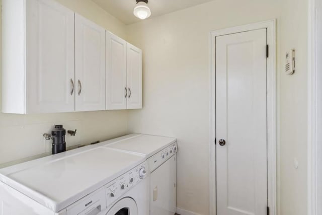 laundry room featuring cabinets and separate washer and dryer