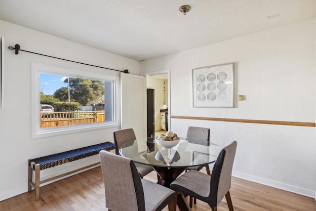 dining area featuring radiator and light hardwood / wood-style flooring