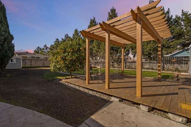 view of community with a wooden deck, a storage shed, and a pergola