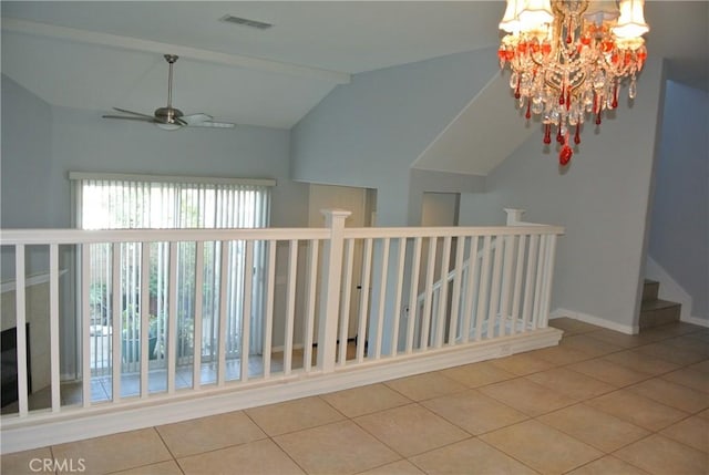 corridor with an inviting chandelier, light tile patterned floors, and lofted ceiling