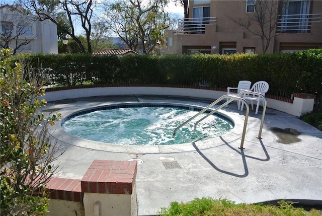 view of pool with a hot tub and a patio