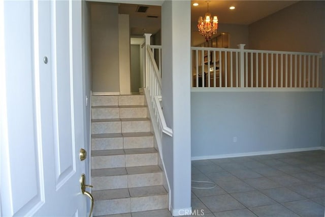 staircase featuring tile patterned flooring and a notable chandelier