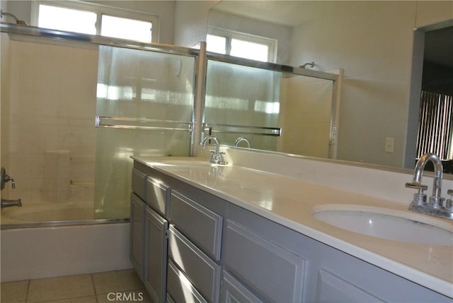 bathroom featuring tile patterned flooring, vanity, and shower / bath combination with glass door