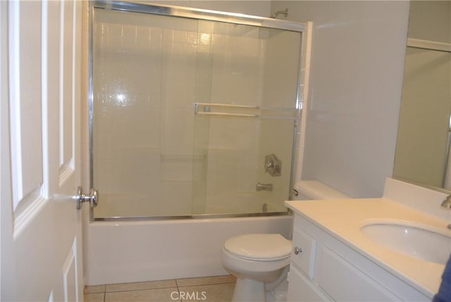 full bathroom with shower / bath combination with glass door, vanity, toilet, and tile patterned flooring