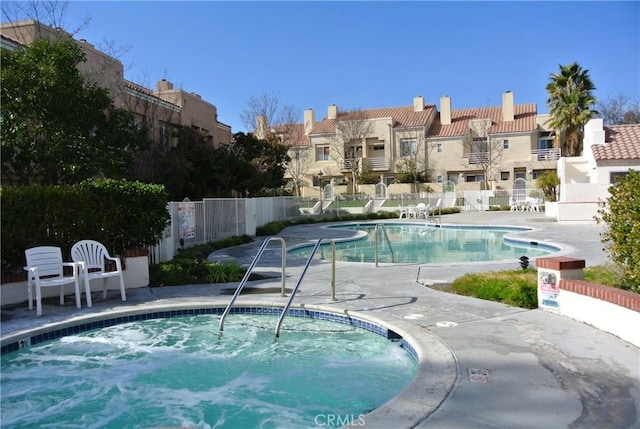 view of pool featuring a hot tub and a patio