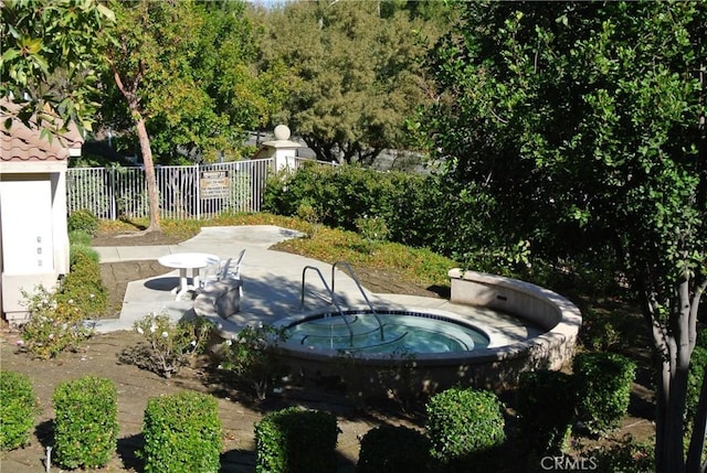 view of swimming pool featuring a community hot tub and a patio area