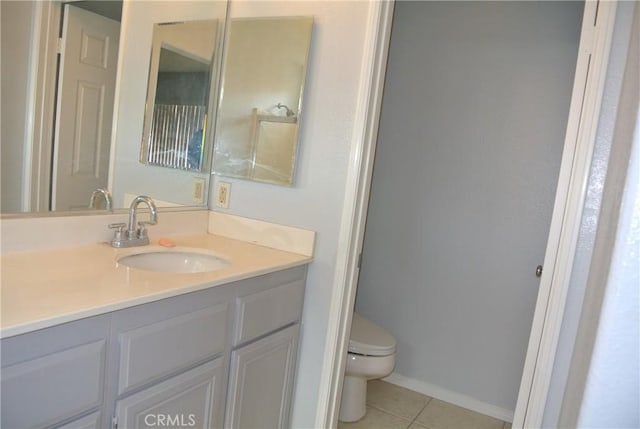 bathroom featuring vanity, tile patterned floors, and toilet