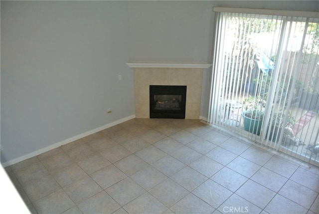 unfurnished living room with a fireplace and light tile patterned floors