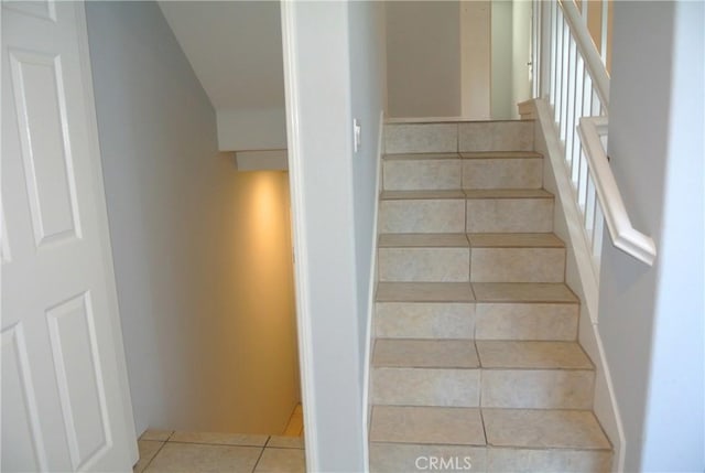 staircase with tile patterned floors