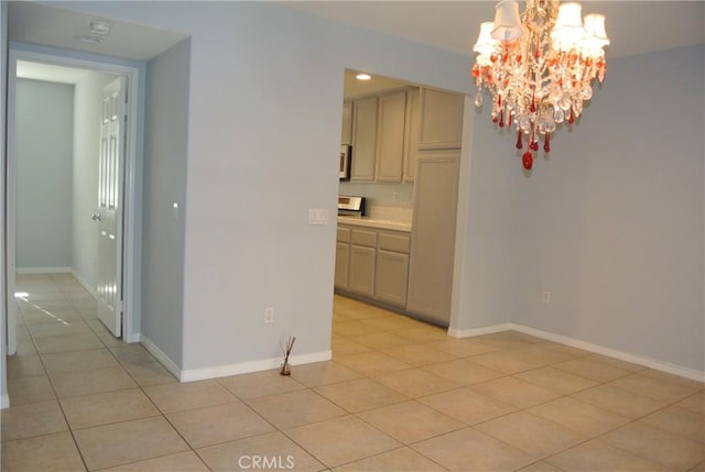 unfurnished dining area featuring light tile patterned floors and a chandelier