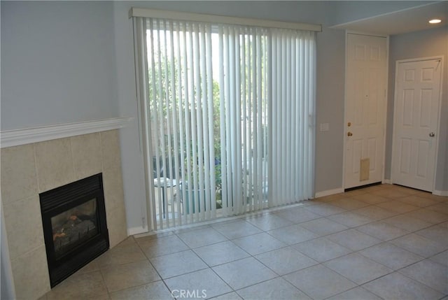 unfurnished living room featuring a fireplace and light tile patterned floors