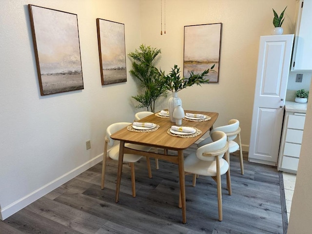 dining area with dark hardwood / wood-style flooring