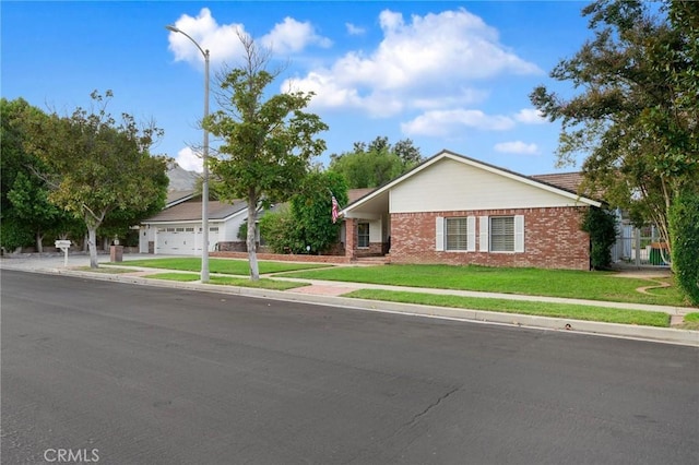 ranch-style home featuring a garage and a front lawn