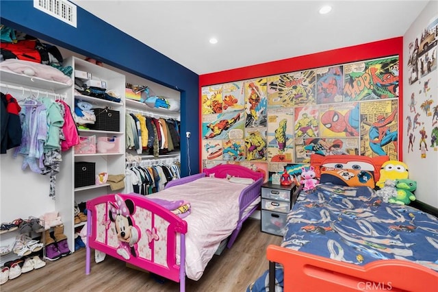 bedroom with a closet and hardwood / wood-style flooring