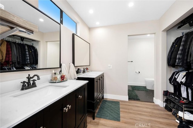 bathroom featuring hardwood / wood-style floors, toilet, and vanity