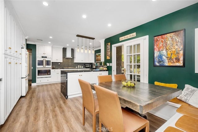 dining space with light wood-type flooring