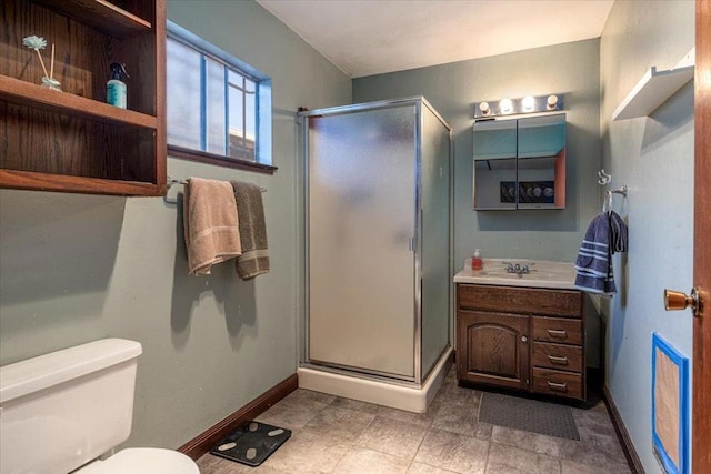 bathroom featuring toilet, a shower with shower door, and vanity