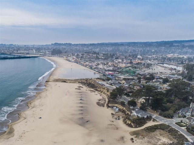 birds eye view of property with a water view and a view of the beach