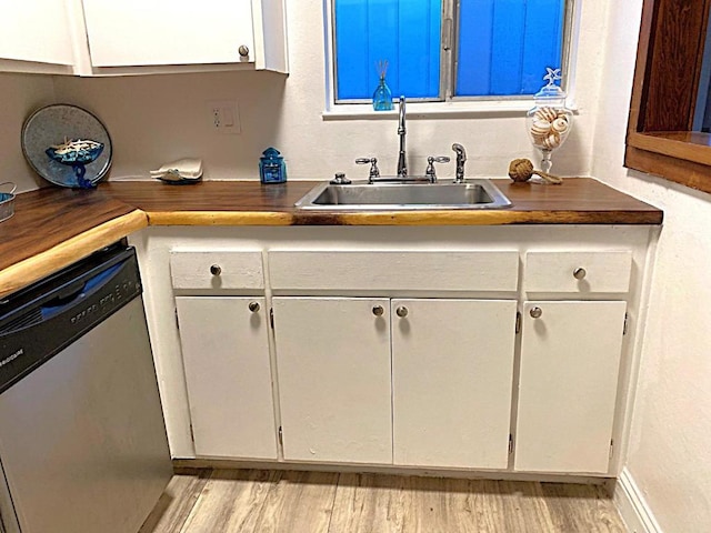 kitchen featuring sink, white cabinets, light wood-type flooring, and dishwasher