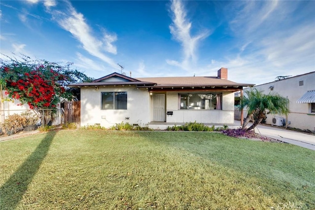 bungalow-style house with a front lawn