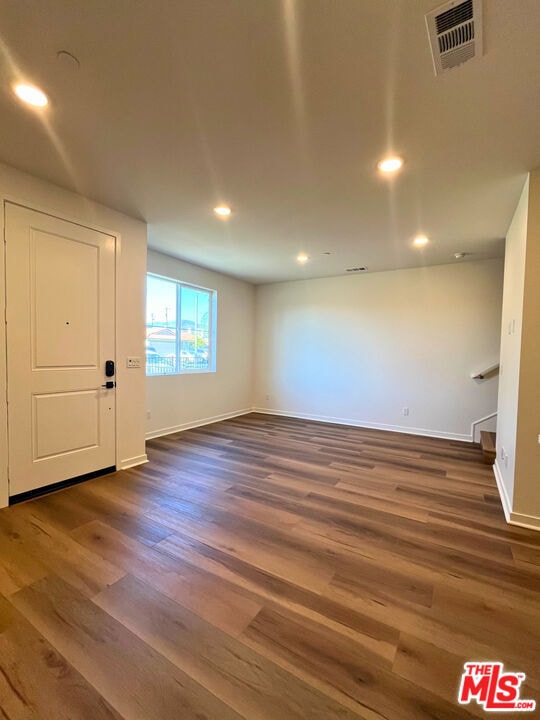 interior space with dark hardwood / wood-style floors