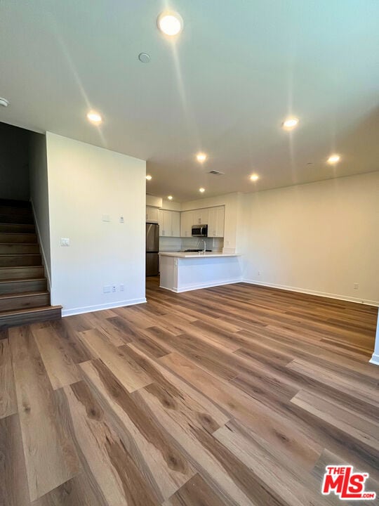 unfurnished living room featuring light wood-type flooring