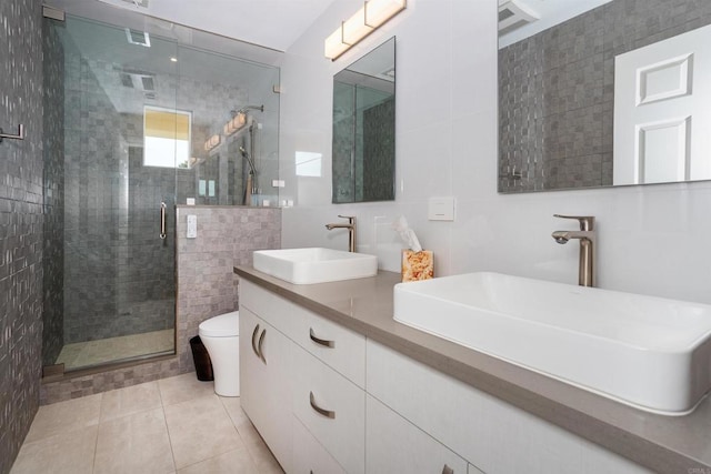 bathroom featuring tile walls, tile patterned floors, vanity, and an enclosed shower