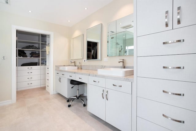 bathroom featuring an enclosed shower and vanity