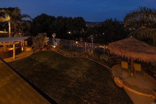 yard at twilight featuring a patio