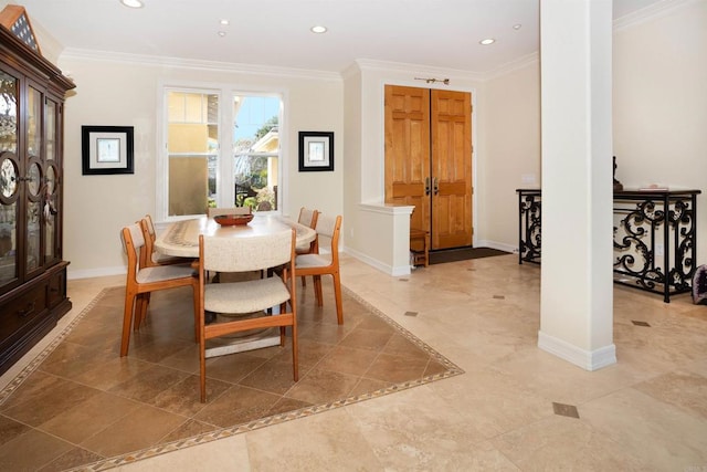 dining area featuring decorative columns and ornamental molding