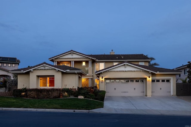 view of front facade with a garage and a front lawn