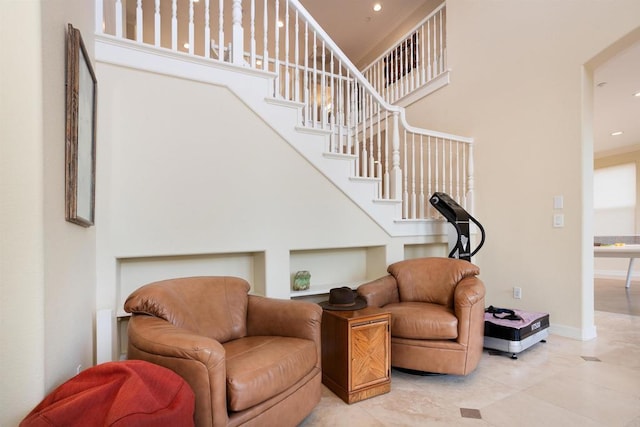 interior space with a high ceiling and tile patterned flooring