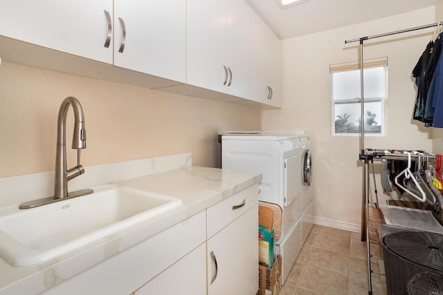 washroom with sink, separate washer and dryer, cabinets, and light tile patterned flooring