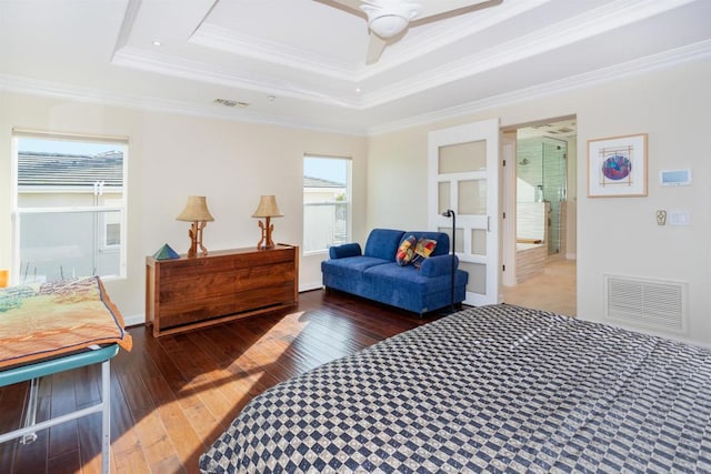 bedroom featuring multiple windows, a tray ceiling, ceiling fan, and ornamental molding